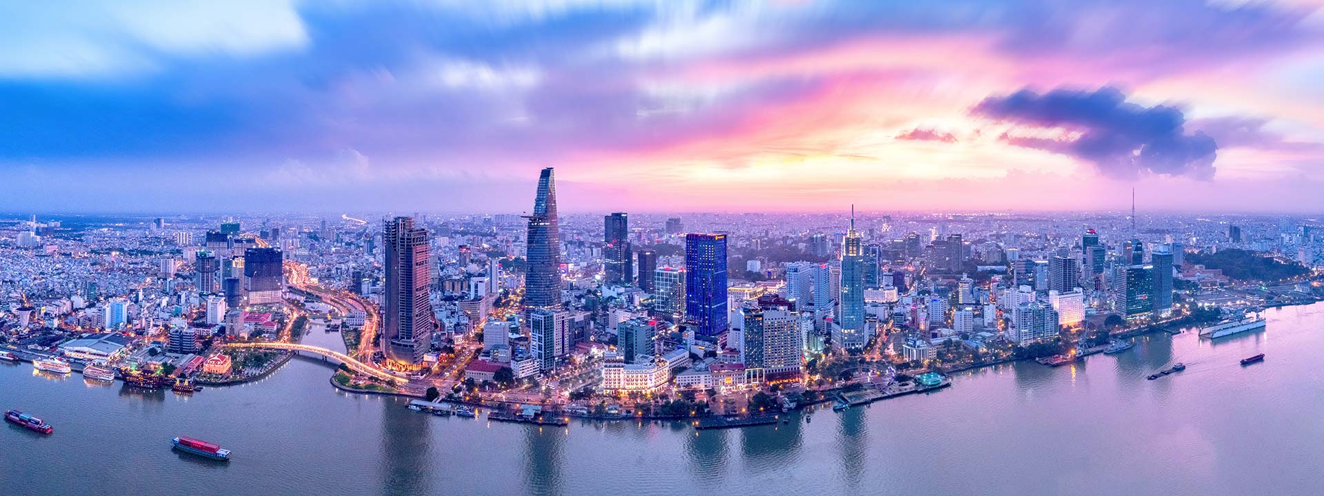 Top view aerial photo from flying drone of a Ho Chi Minh City with development buildings, transportation, energy power infrastructure. Financial and business centers in developed Vietnam.